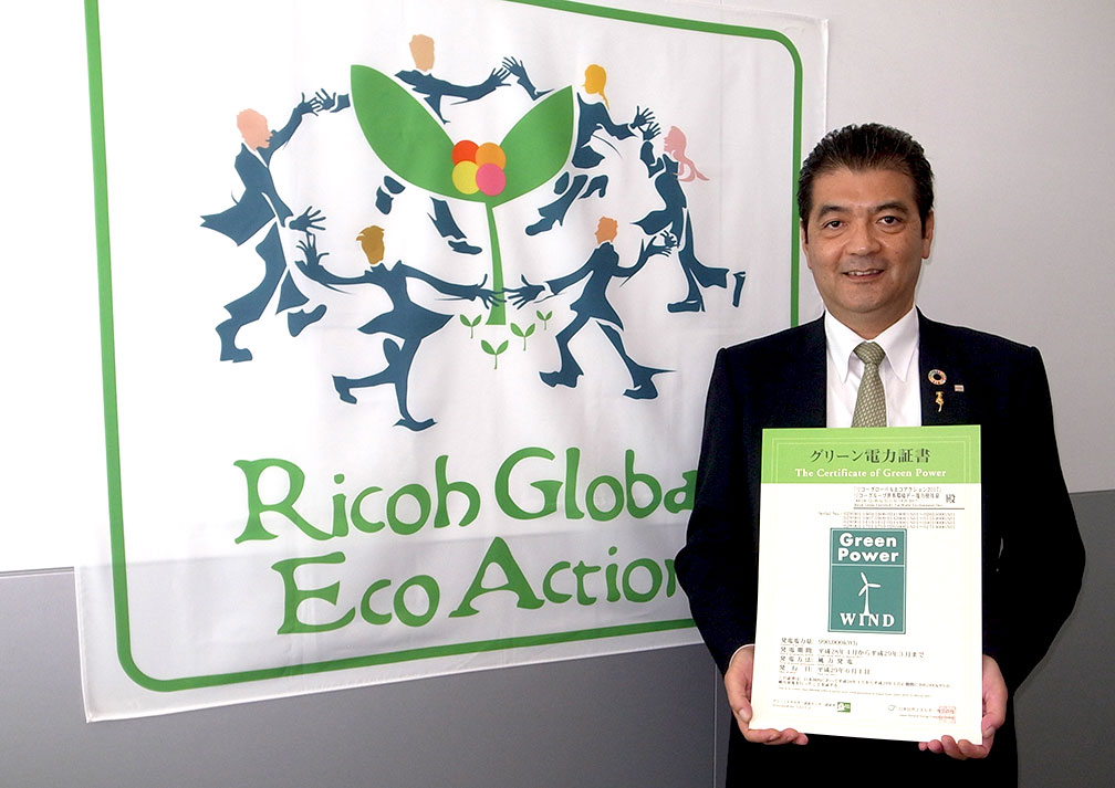 Mr. Shigeo Kato, General Manager of the Sustainability Management Division holding the Renewable Energy Certificate