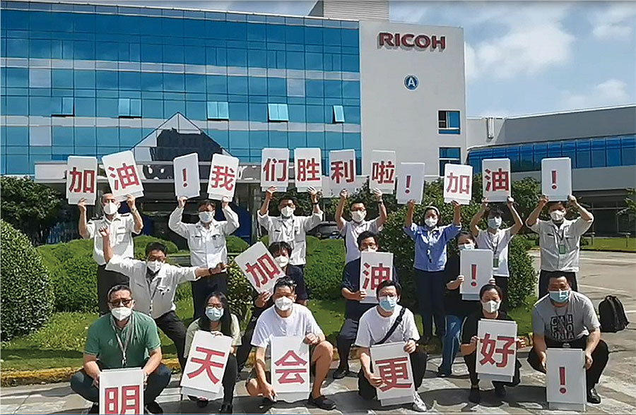 Project team members celebrating their Ricoh Way Values Awards grand prize