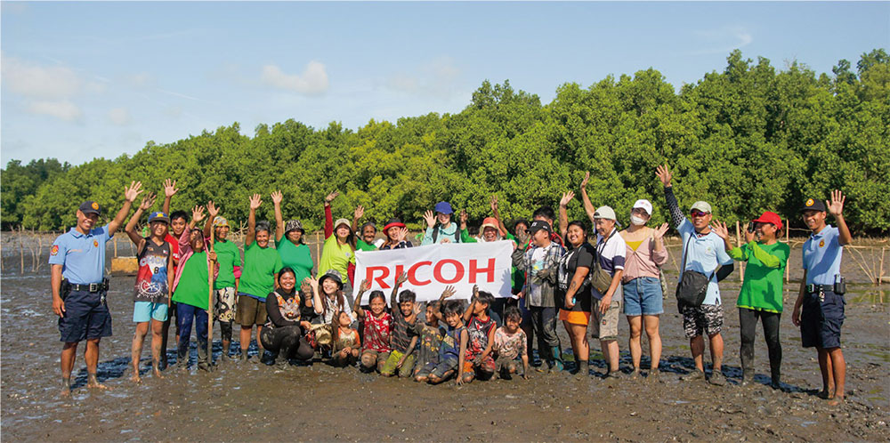 Participants engaged in mangrove planting in Southeast Asia